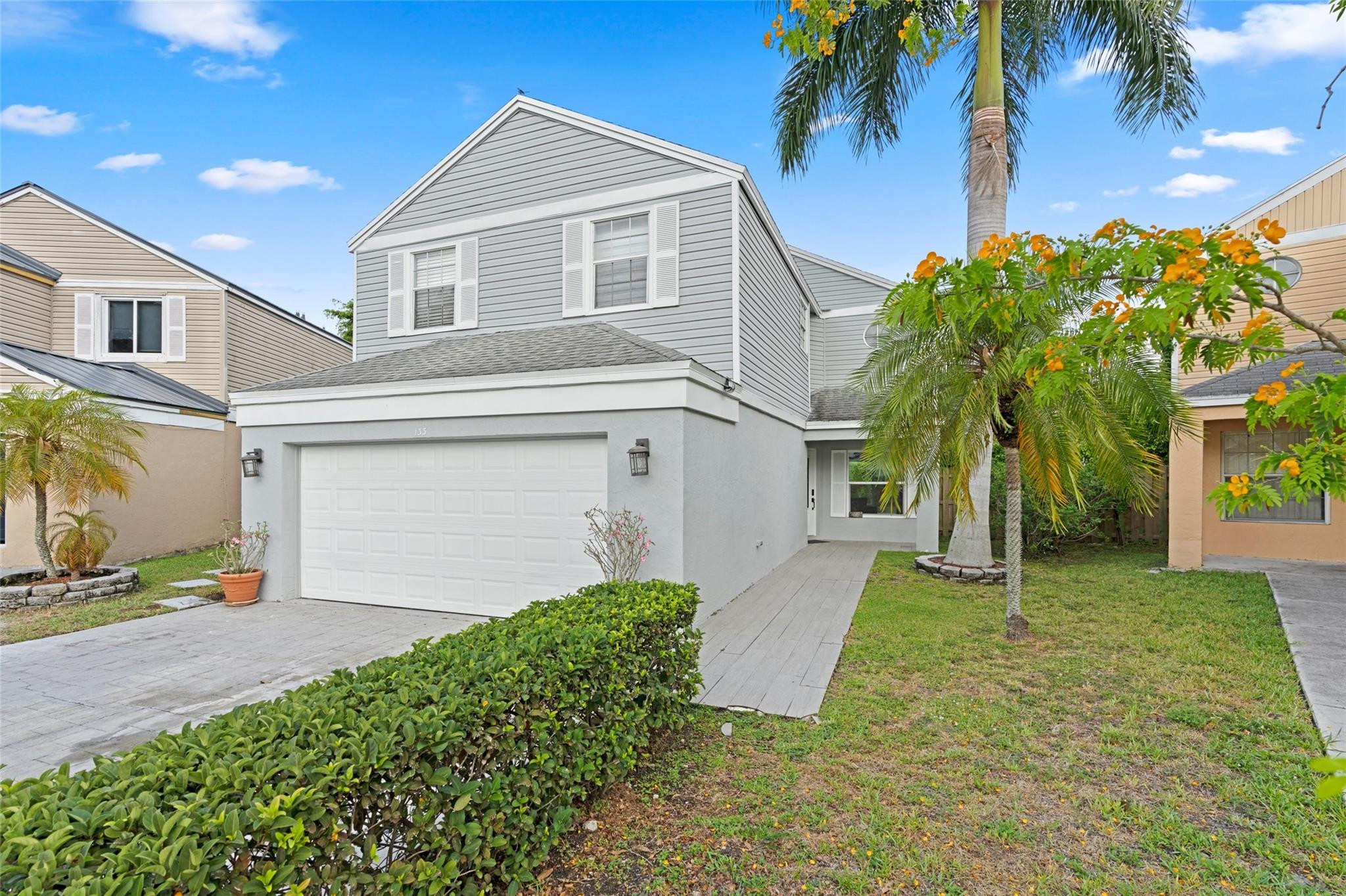 a front view of a house with a yard and garage
