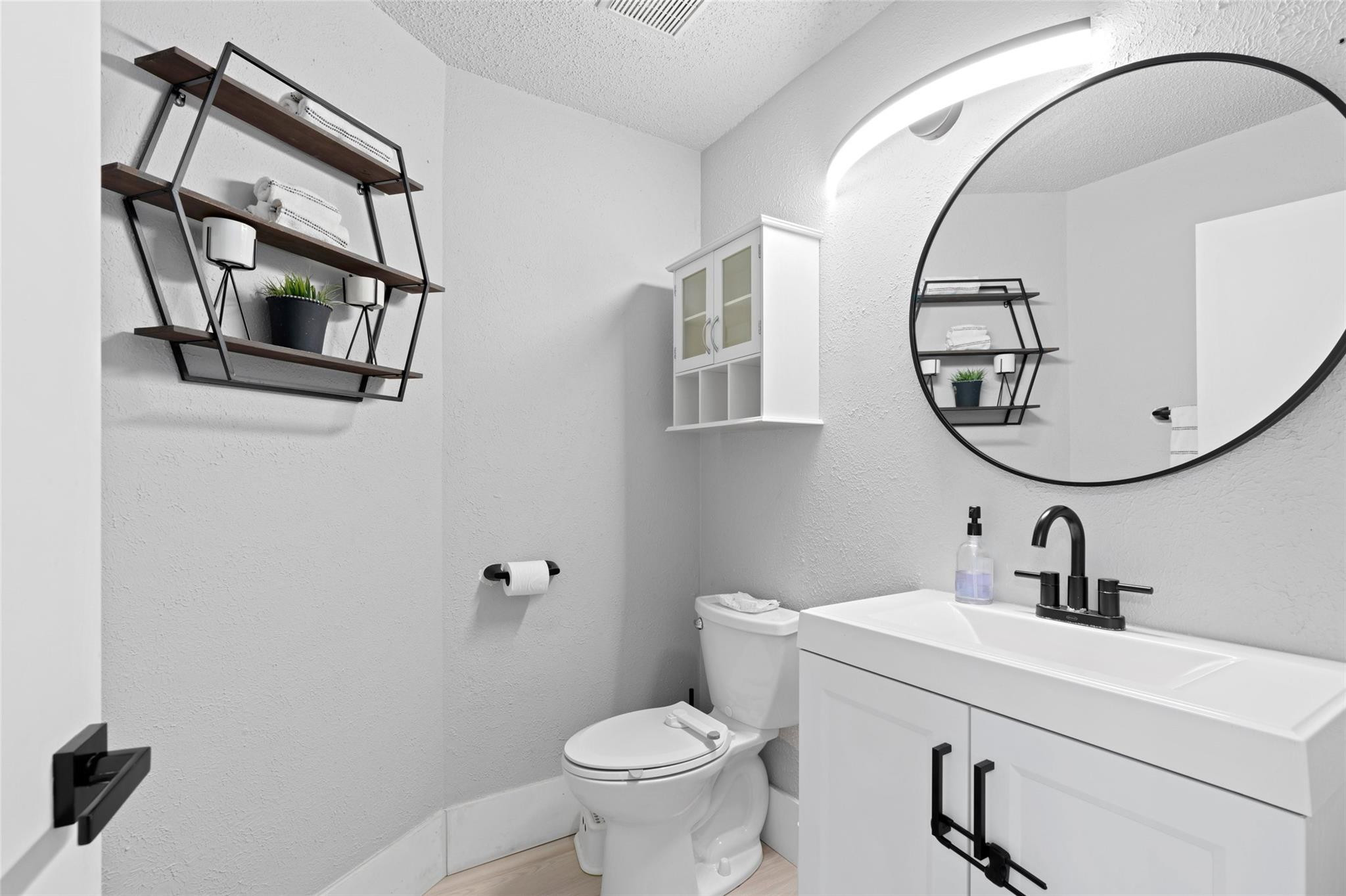 133 Southwest 159th Way Sunrise, FL 33326 - Photo 13 of 38 a bathroom with a toilet sink and mirror