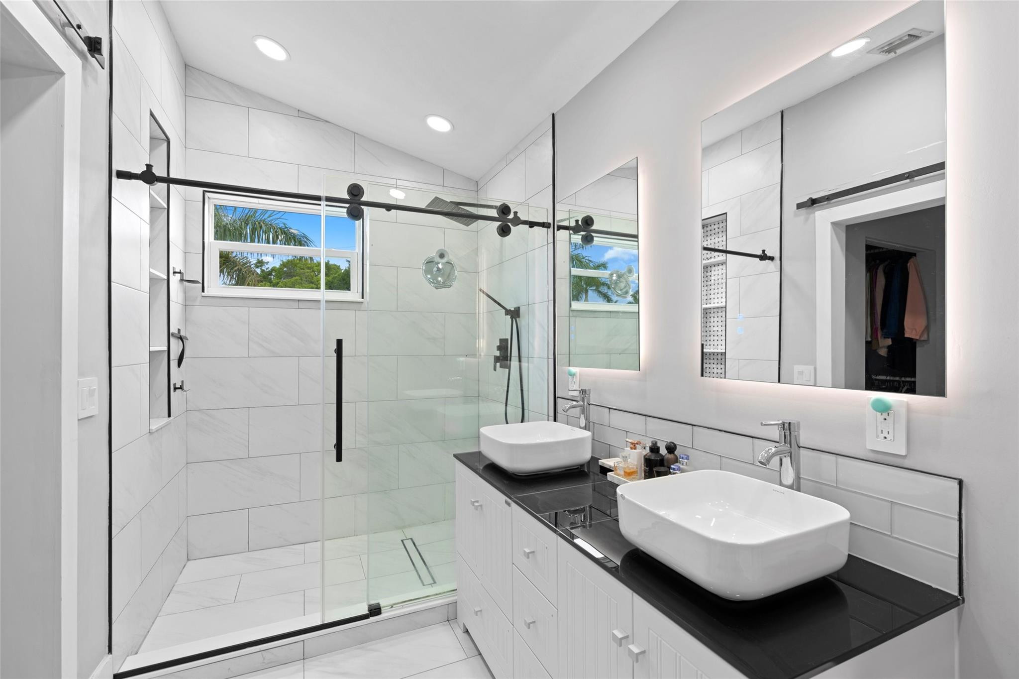 133 Southwest 159th Way Sunrise, FL 33326 - Photo 19 of 38 a bathroom with a double vanity sink mirror and shower