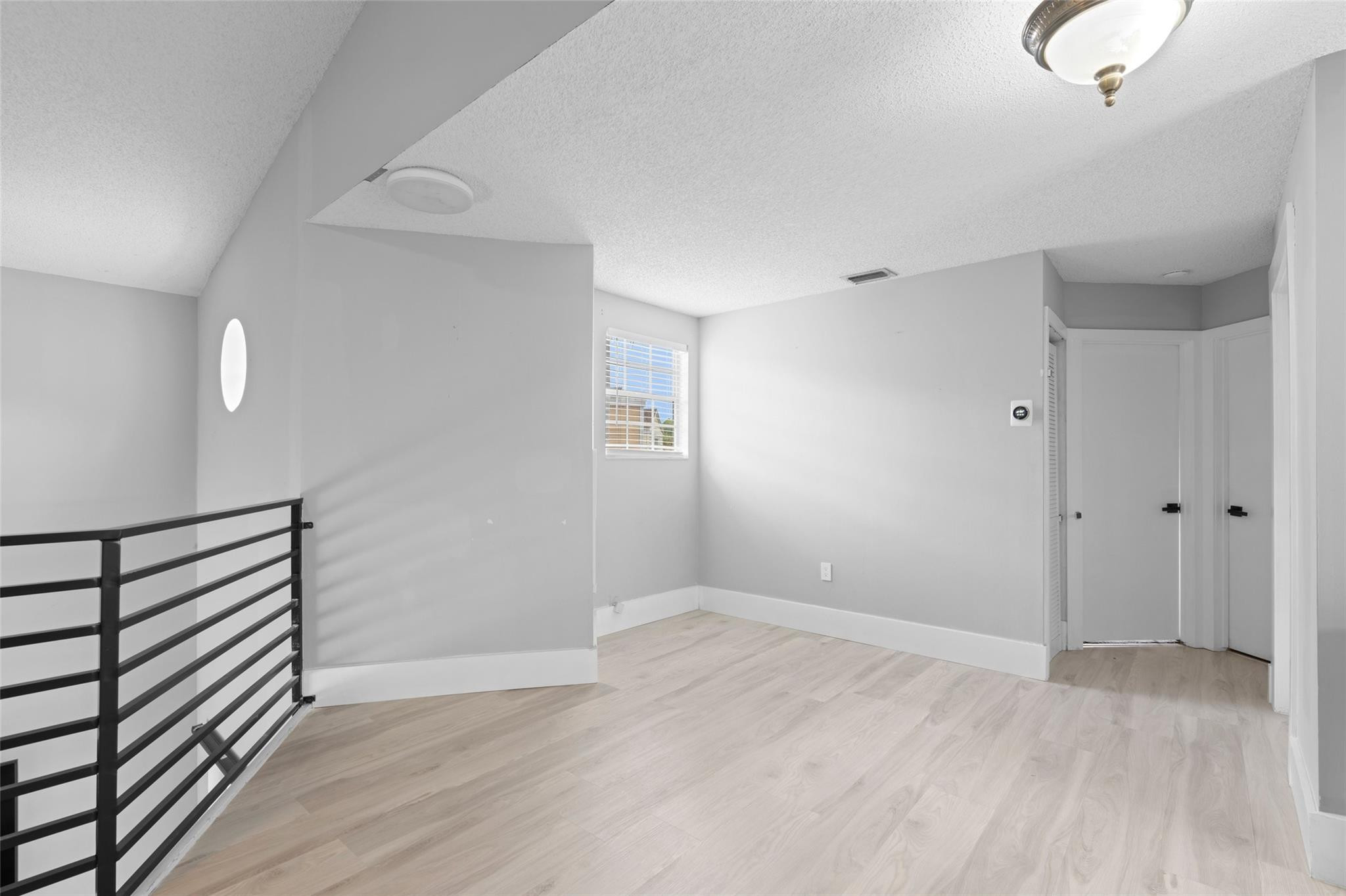 133 Southwest 159th Way Sunrise, FL 33326 - Photo 20 of 38 a view of an empty room with wooden floor