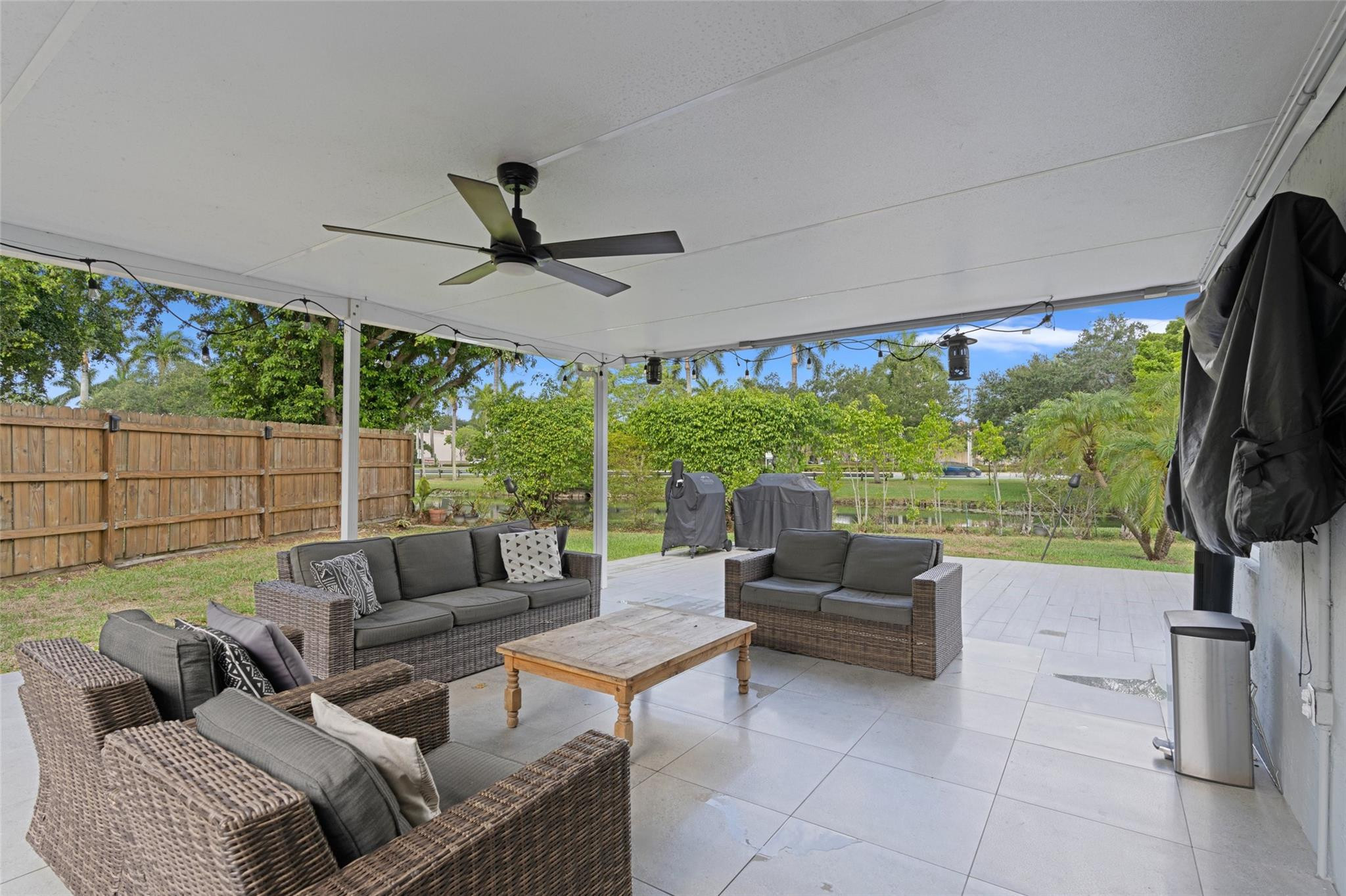 133 Southwest 159th Way Sunrise, FL 33326 - Photo 37 of 38 a living room with patio furniture and a flat screen tv