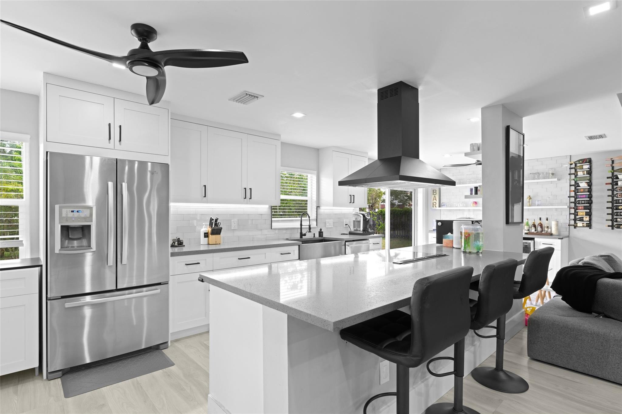 133 Southwest 159th Way Sunrise, FL 33326 - Photo 8 of 38 a kitchen with stainless steel appliances a refrigerator a stove a dining table and chairs with wooden floor