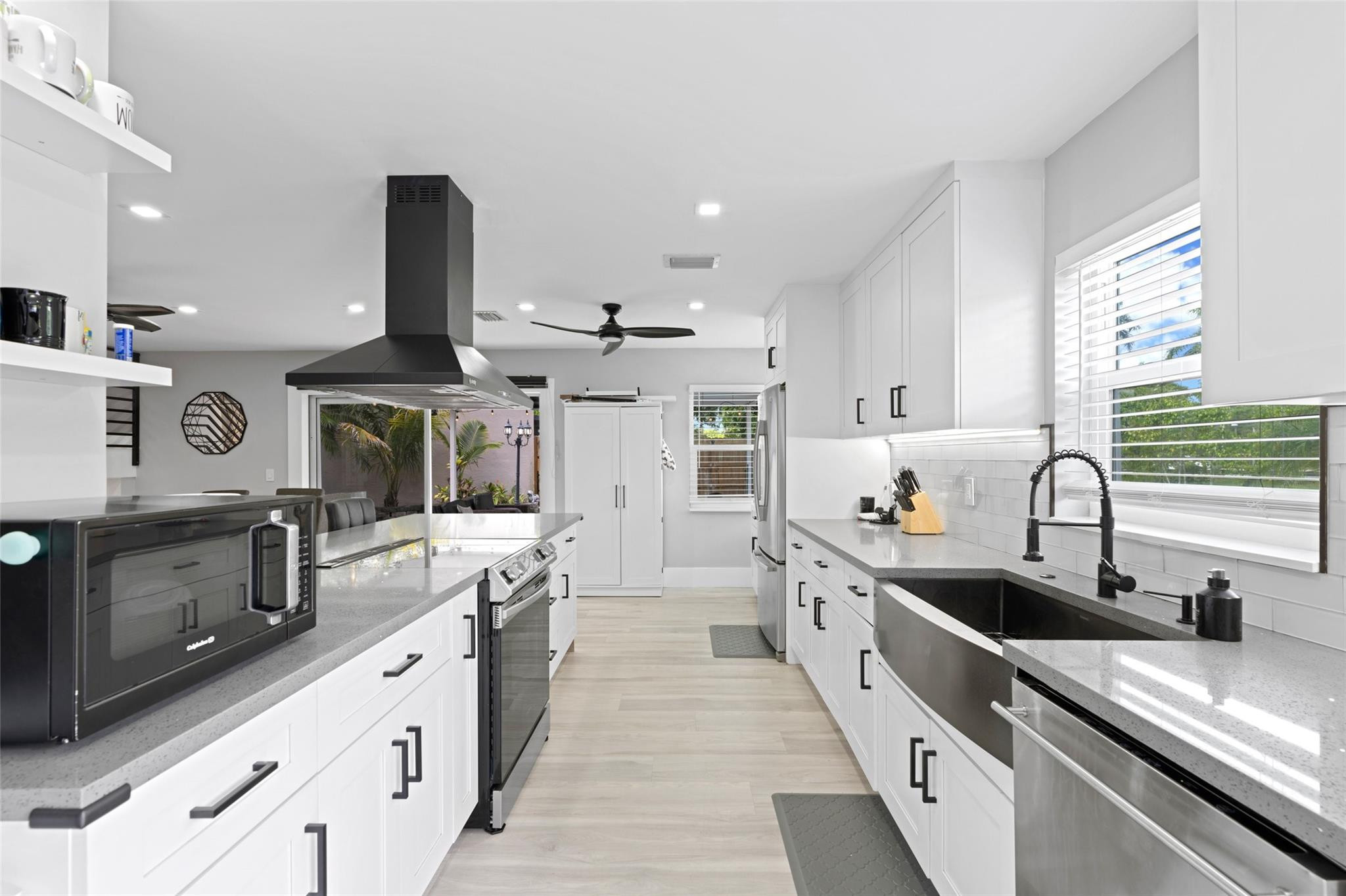 133 Southwest 159th Way Sunrise, FL 33326 - Photo 10 of 38 a large kitchen with stainless steel appliances lots of counter space sink and a window