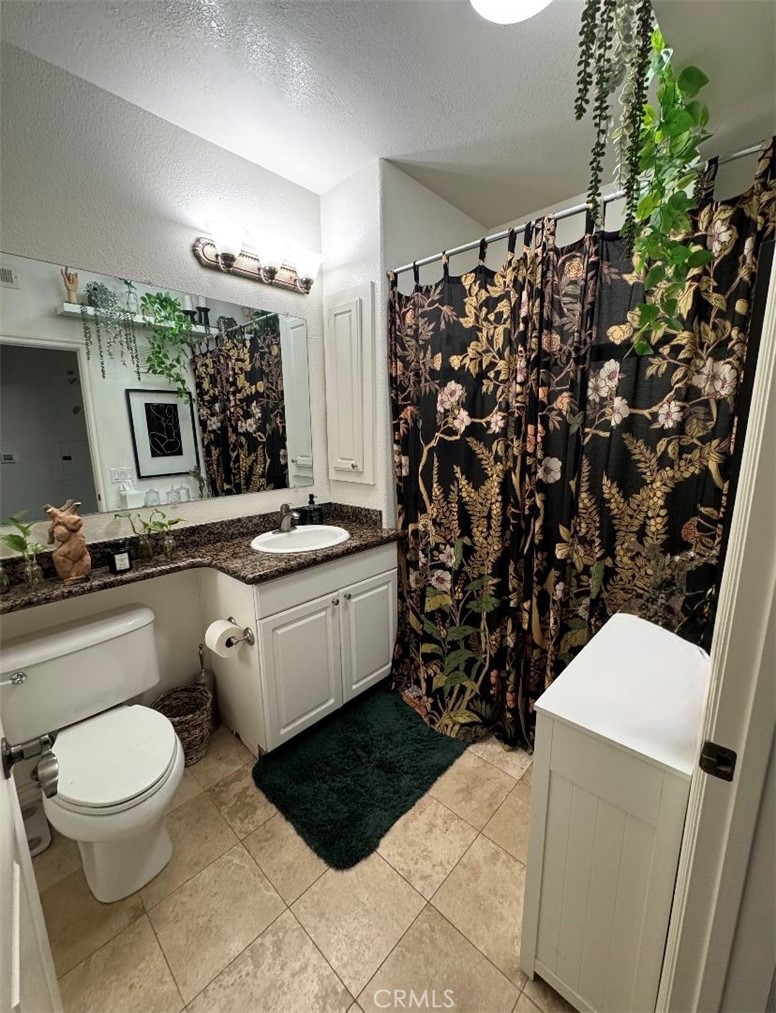 9293 Regents Road, Unit C303 La Jolla, CA 92037 - Photo 7 of 9 a bathroom with a sink toilet and shower