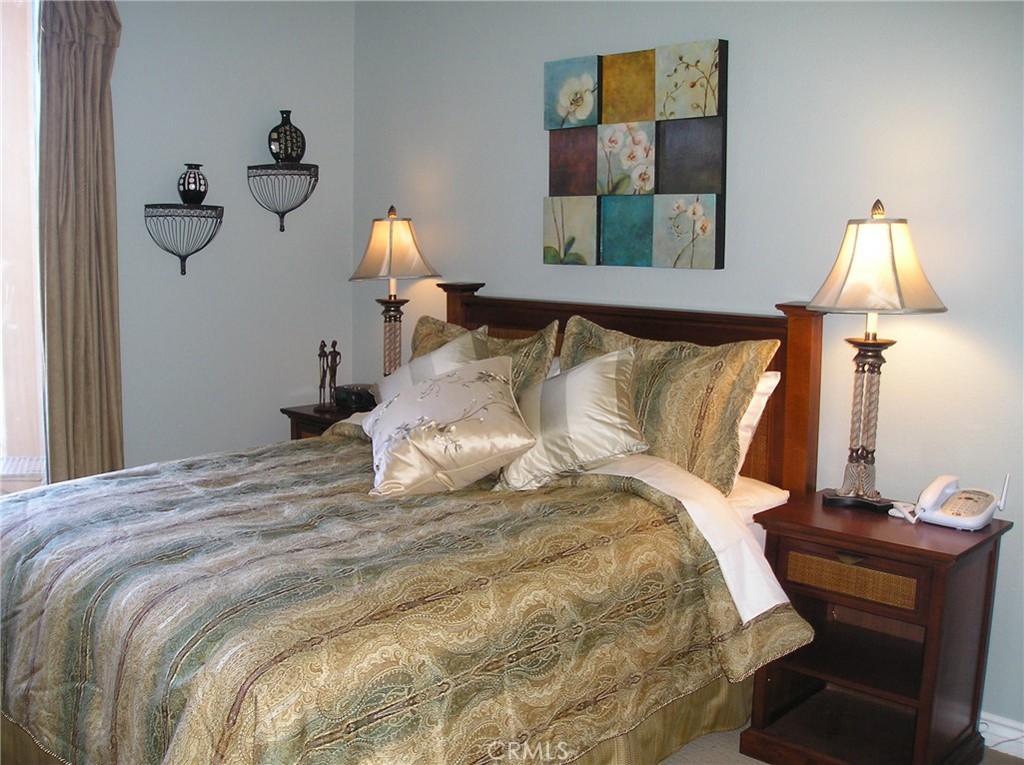 9293 Regents Road, Unit C303 La Jolla, CA 92037 - Photo 9 of 9 a bedroom with a bed and wooden floor