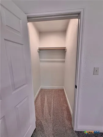 a view of walk in closet with cabinet