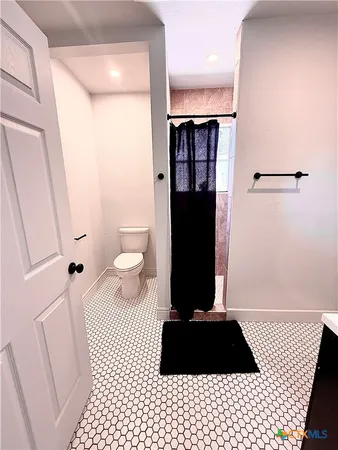 a view of a black and white wall with a shower