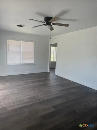 a view of large kitchen with wooden floor and electronic appliances