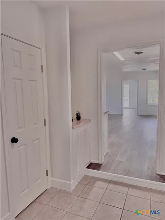 a view of a big room with wooden floor and windows