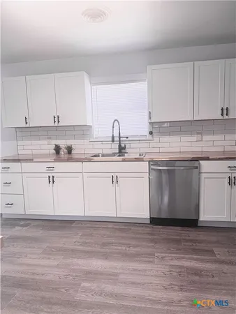 a view of a kitchen sink and a stove