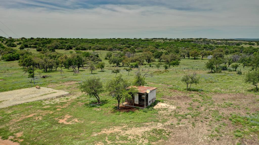 1443 Gina Road Harper, TX 78631 - Photo 3 of 49 a view of a garden with a bench in a yard