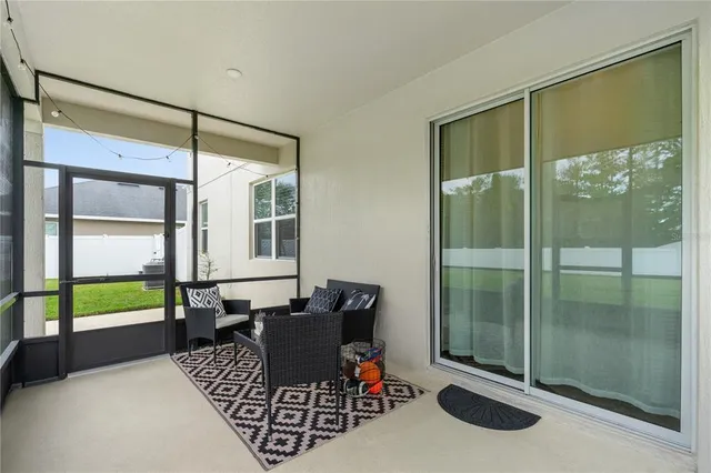 a living room with furniture and a ceiling fan