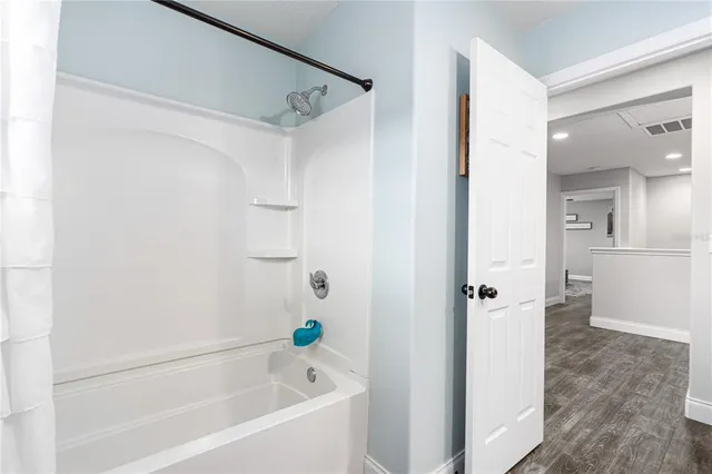 an aerial view of a house with a yard and large trees