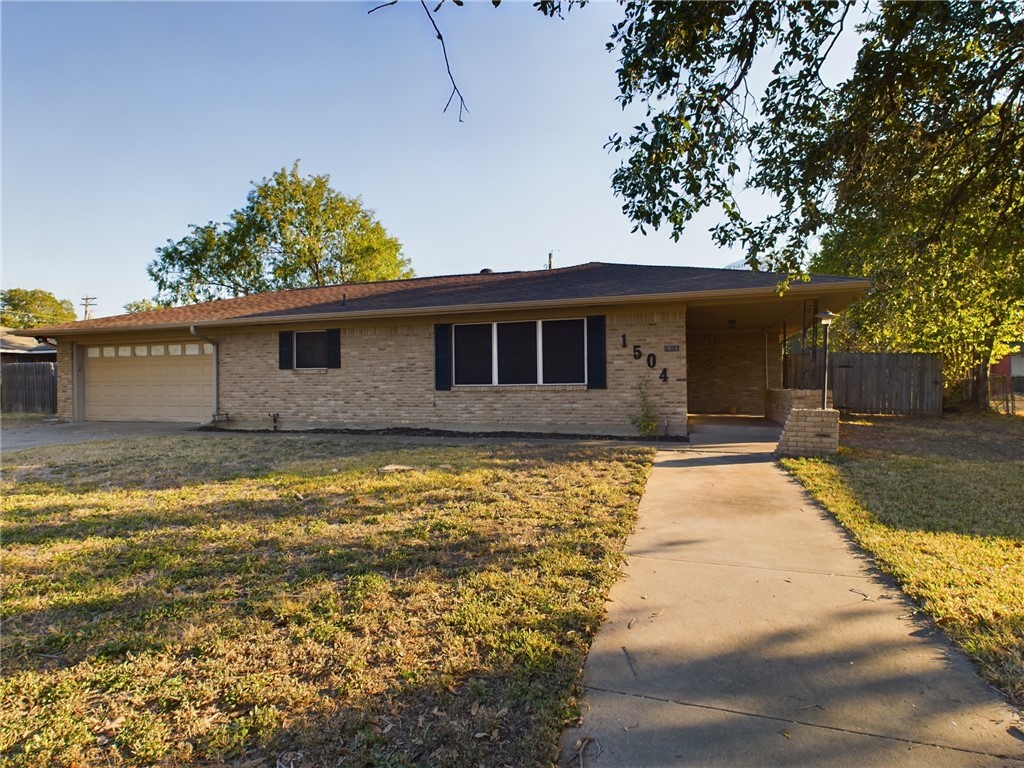 1504 East 29th Street Bryan, TX 77802 - Photo 1 of 19 a front view of a house with a garden