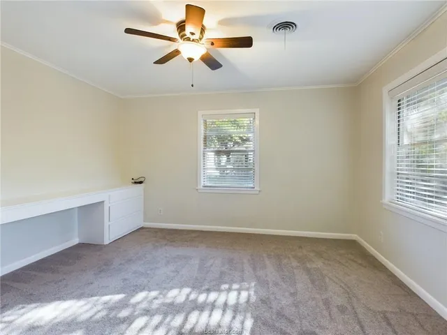 a view of room with a ceiling fan and window