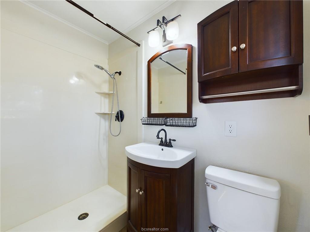 1504 East 29th Street Bryan, TX 77802 - Photo 8 of 19 a bathroom with a sink a toilet and shower