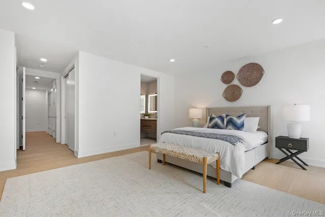 a spacious bedroom with a bed and cabinets