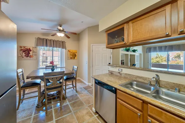 a kitchen with stainless steel appliances granite countertop a sink and a counter space