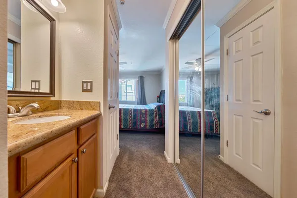 a spacious bathroom with a double vanity sink a mirror and a shower