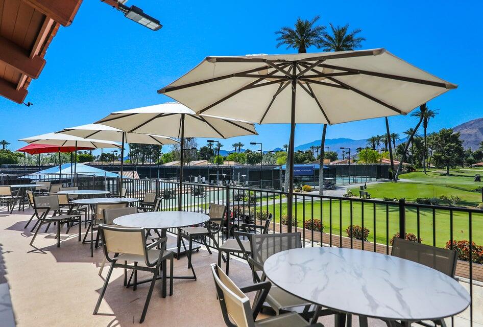 36 Sunrise Drive Rancho Mirage, CA 92270 - Photo 32 of 39 a view of a swimming pool with a table and chairs under an umbrella