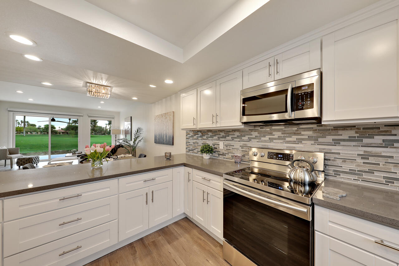 36 Sunrise Drive Rancho Mirage, CA 92270 - Photo 7 of 39 a kitchen with a sink stove and microwave