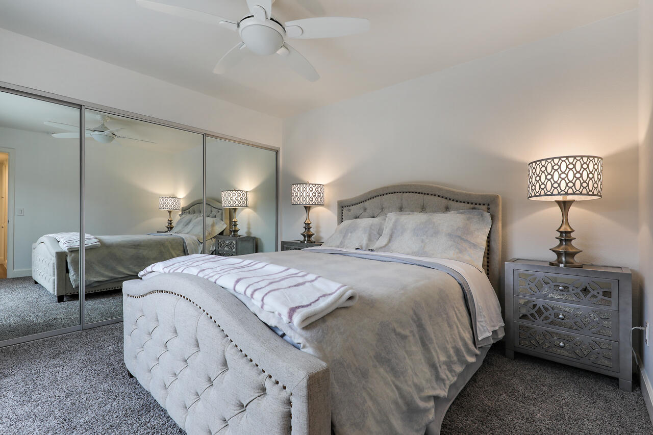 36 Sunrise Drive Rancho Mirage, CA 92270 - Photo 10 of 39 a bedroom with a bed a lamp and a large mirror