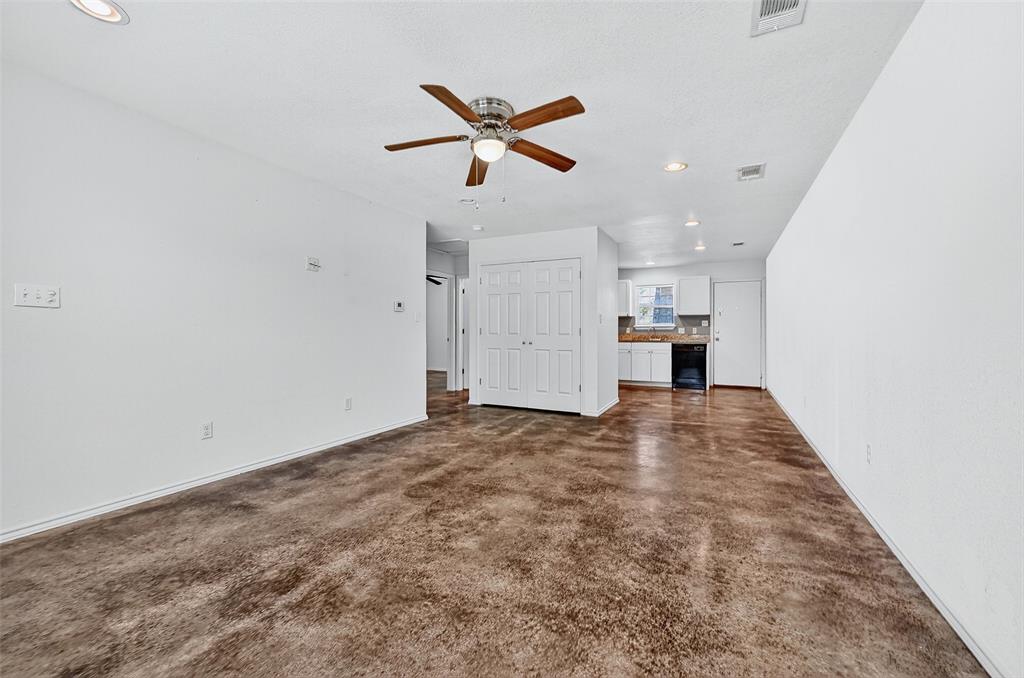 712 Seven Oaks Road, Unit 712 Bonham, TX 75418 - Photo 11 of 39 a view of empty room with wooden floor and ceiling fan