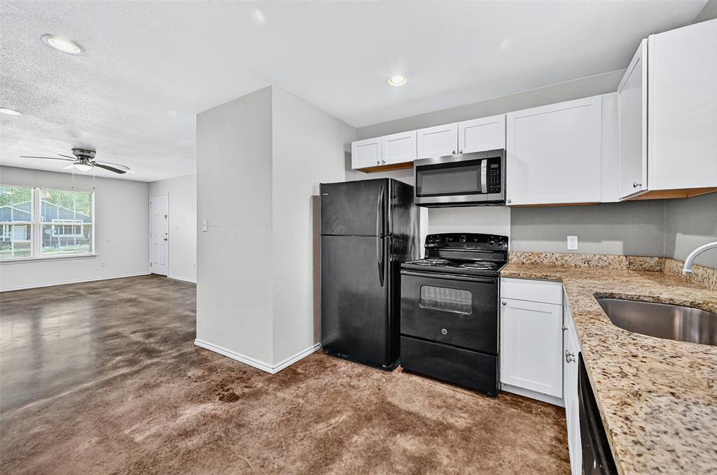 712 Seven Oaks Road, Unit 712 Bonham, TX 75418 - Photo 15 of 39 a kitchen with a refrigerator stove and sink