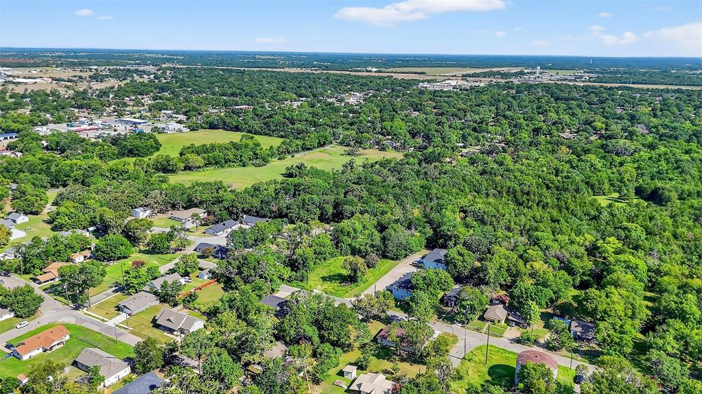 712 Seven Oaks Road, Unit 712 Bonham, TX 75418 - Photo 30 of 39 an aerial view of residential houses with outdoor space and trees