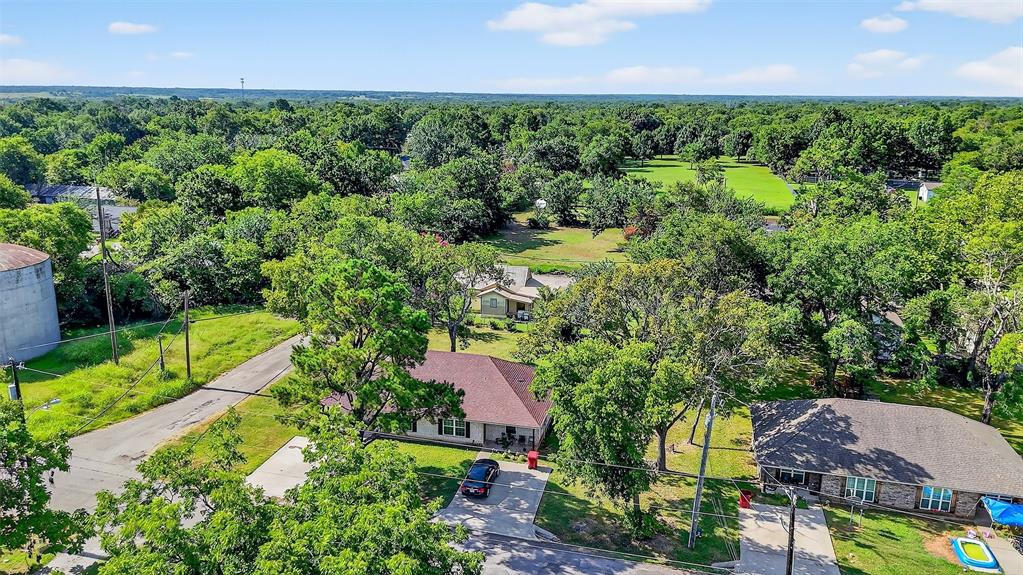 712 Seven Oaks Road, Unit 712 Bonham, TX 75418 - Photo 33 of 39 an aerial view of residential house with outdoor space and trees all around