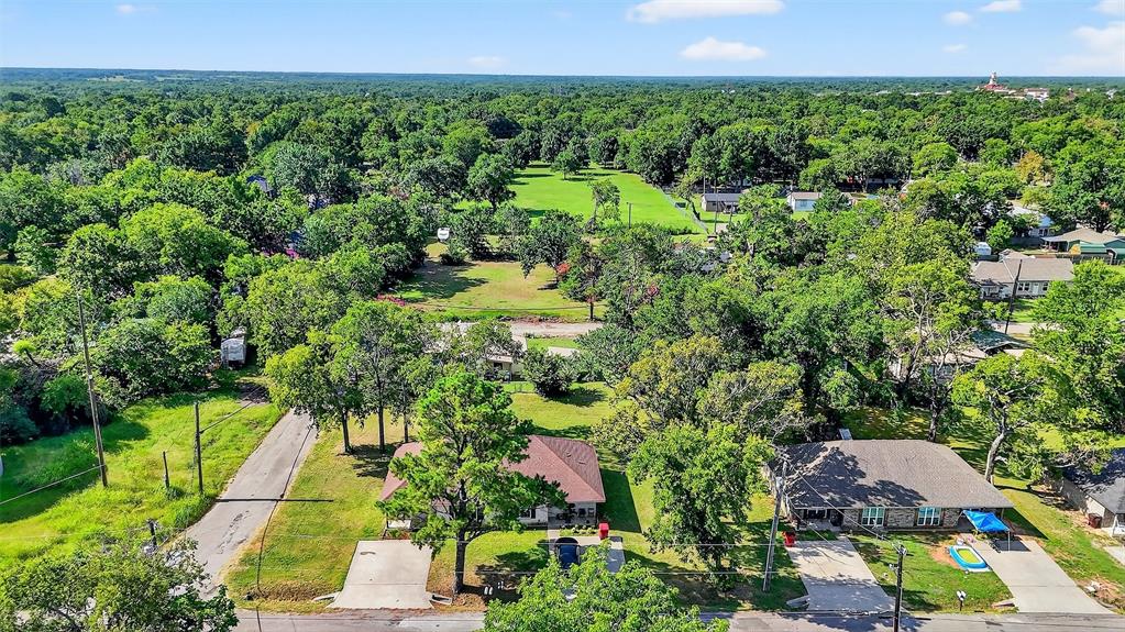 712 Seven Oaks Road, Unit 712 Bonham, TX 75418 - Photo 34 of 39 an aerial view of residential house with outdoor space and trees all around