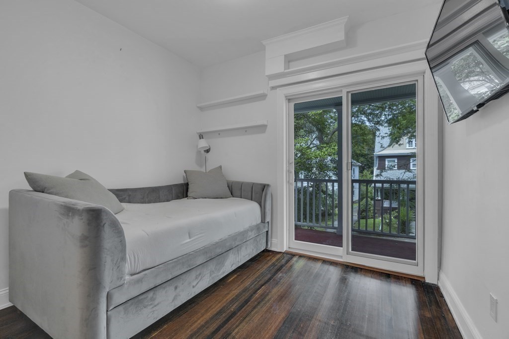 29 Walton Street, Unit 2 Boston, MA 02124 - Photo 11 of 21 a bed room with a bed and a large window