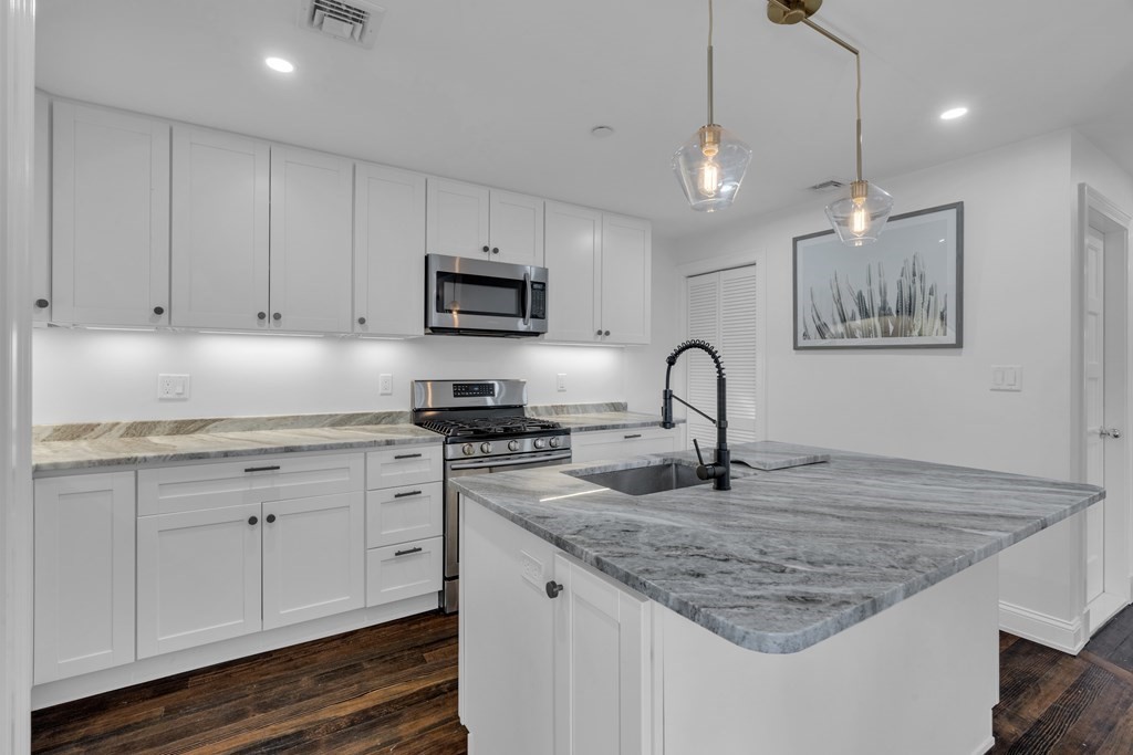 29 Walton Street, Unit 2 Boston, MA 02124 - Photo 2 of 21 a kitchen with granite countertop a sink and a stove