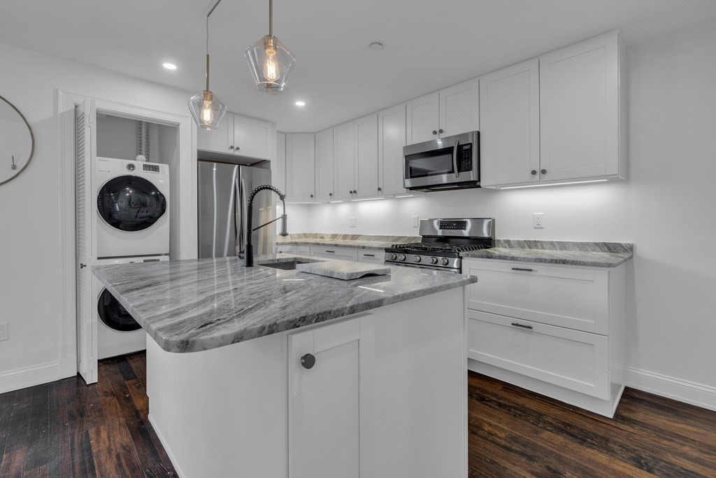 29 Walton Street, Unit 2 Boston, MA 02124 - Photo 3 of 21 a kitchen with a sink stainless steel appliances and white cabinets