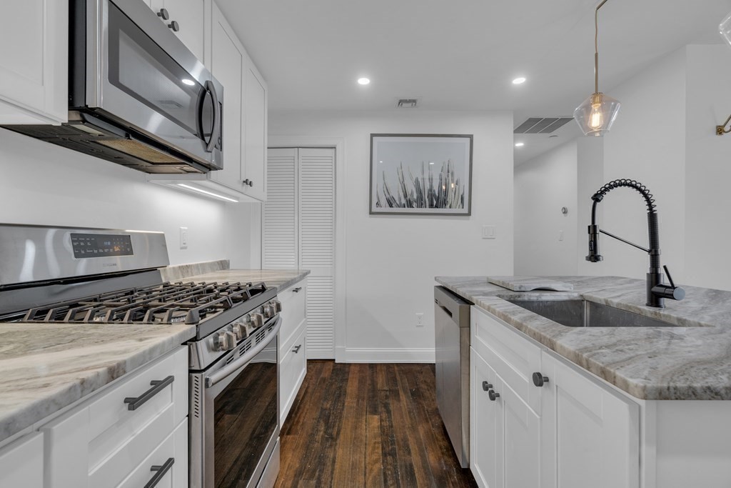 29 Walton Street, Unit 2 Boston, MA 02124 - Photo 5 of 21 a kitchen with stainless steel appliances granite countertop a stove and a sink
