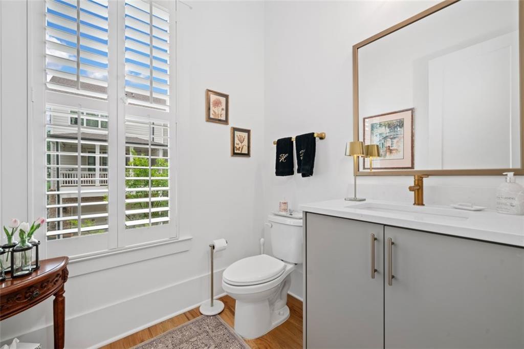 1045 Endeavour Court Marietta, GA 30064 - Photo 16 of 39 a bathroom with a toilet a sink and mirror