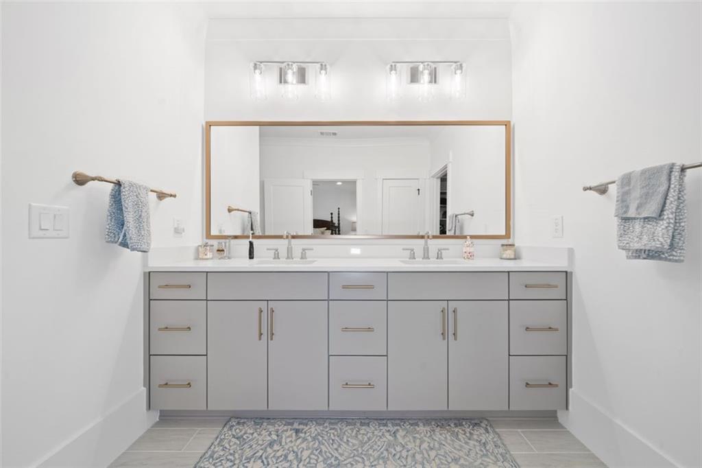 1045 Endeavour Court Marietta, GA 30064 - Photo 21 of 39 a bathroom with a sink vanity and mirror