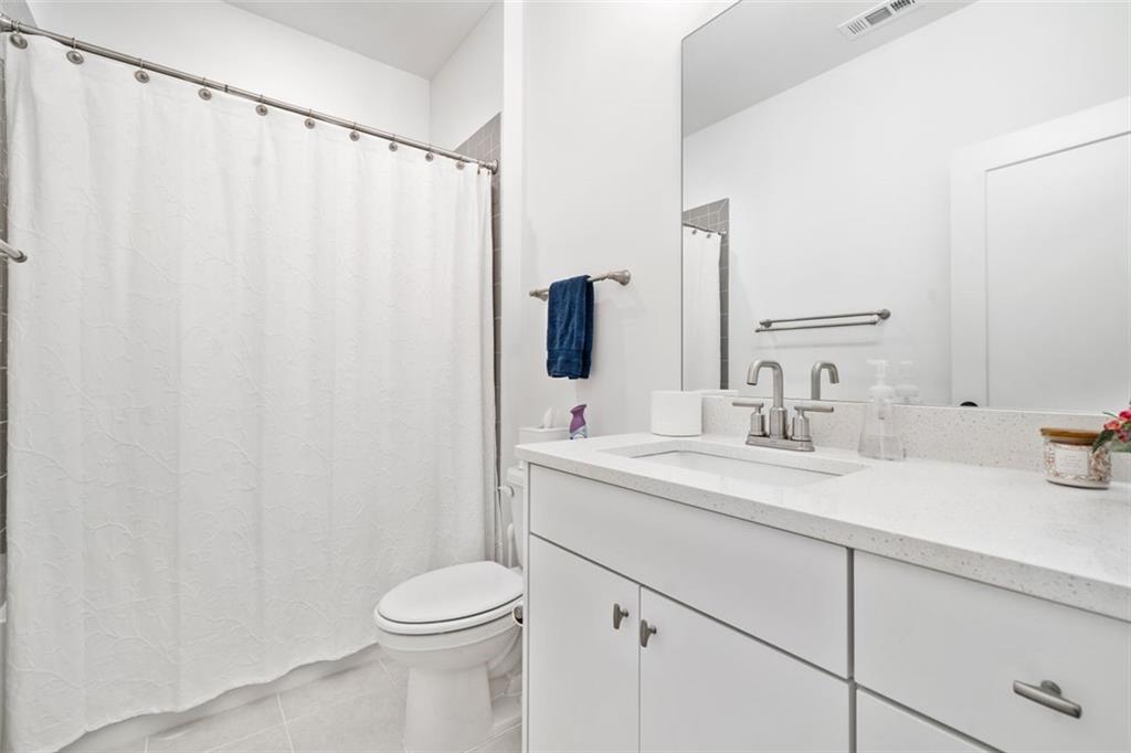 1045 Endeavour Court Marietta, GA 30064 - Photo 28 of 39 a bathroom with a sink a toilet and a mirror