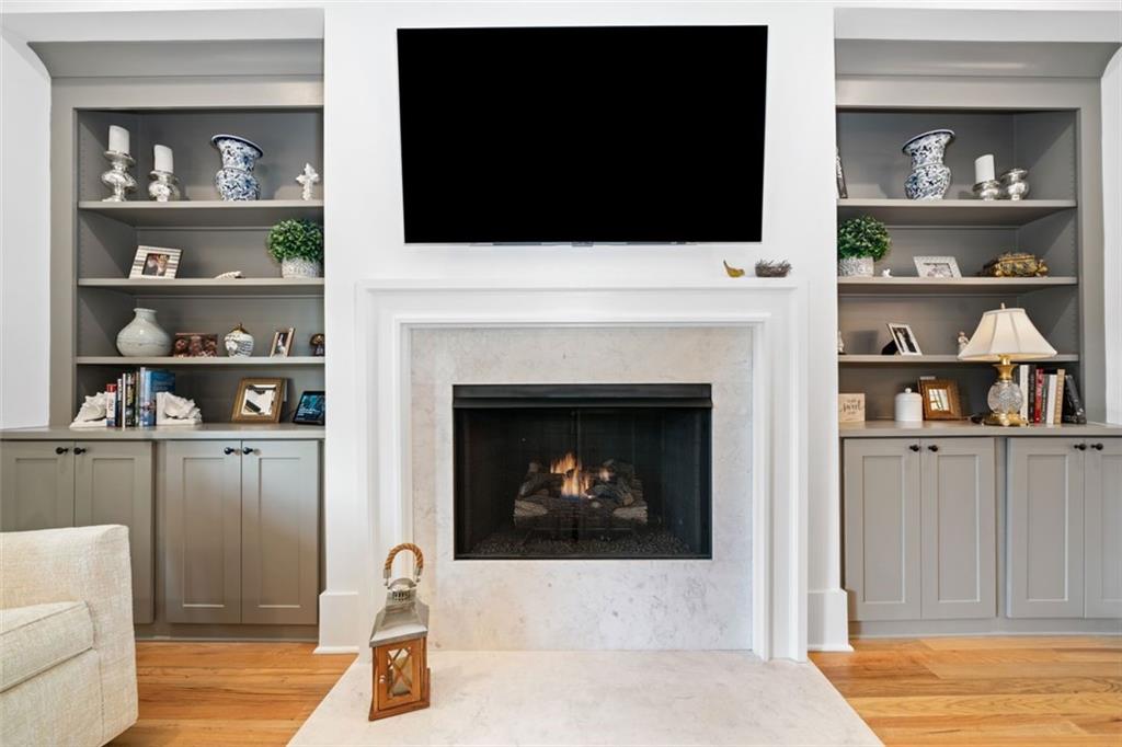1045 Endeavour Court Marietta, GA 30064 - Photo 6 of 39 a living room with a fireplace and a flat screen tv