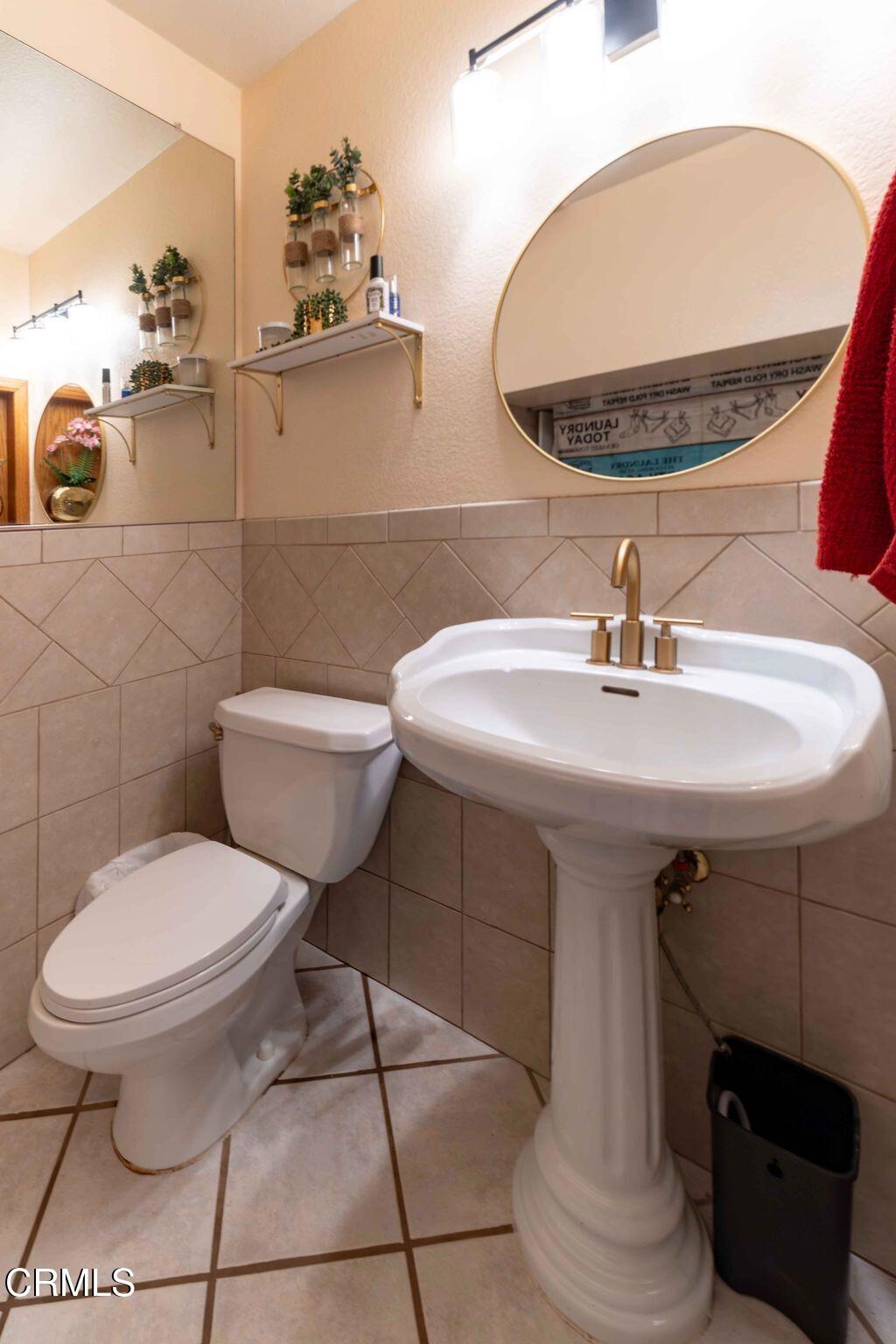 635 East Pleasant Valley Road Port Hueneme, CA 93041 - Photo 11 of 17 a bathroom with a sink toilet and a mirror