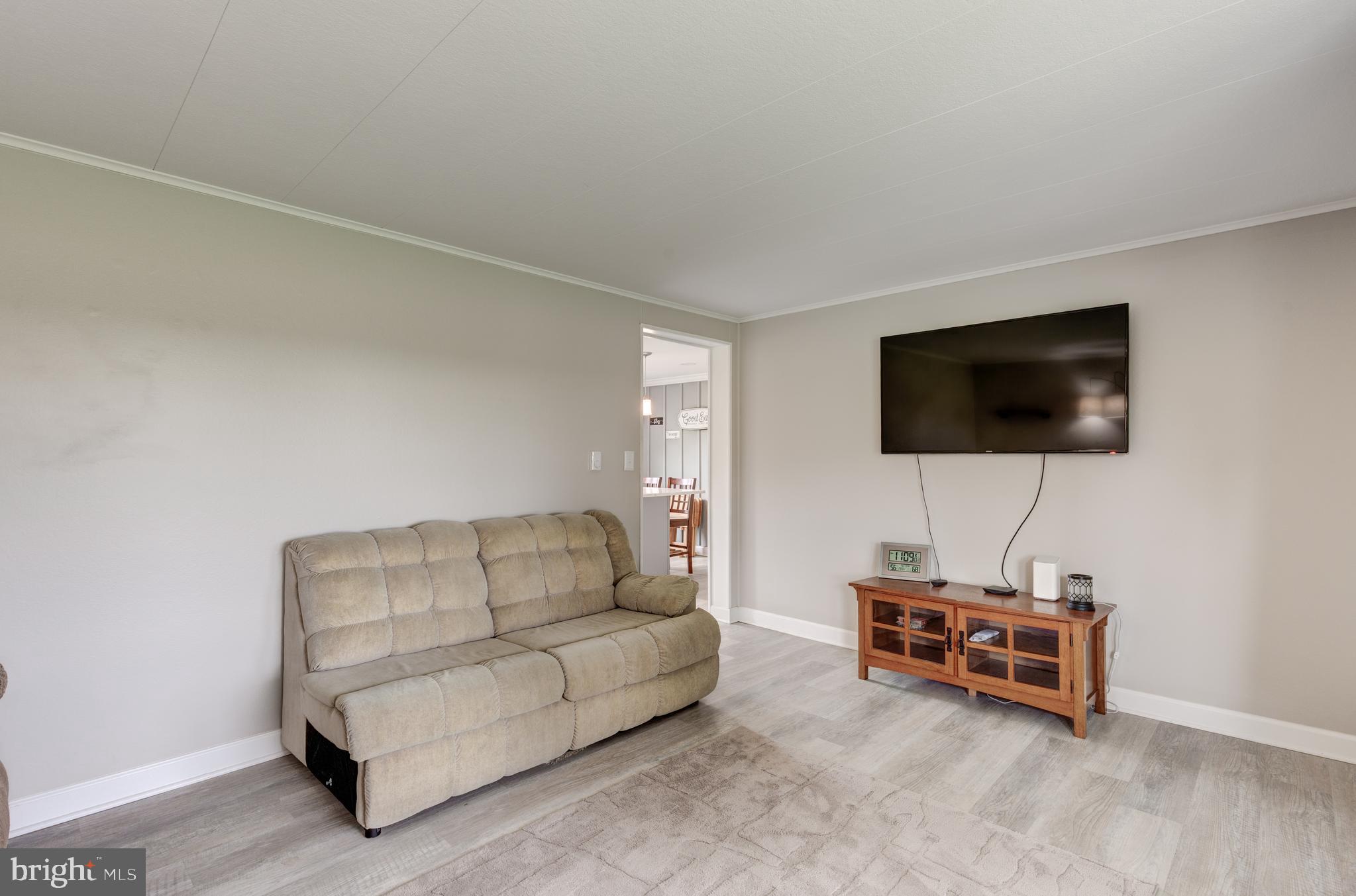 3801 Carrollton Road Upperco, MD 21155 - Photo 20 of 75 a living room with furniture and a flat screen tv