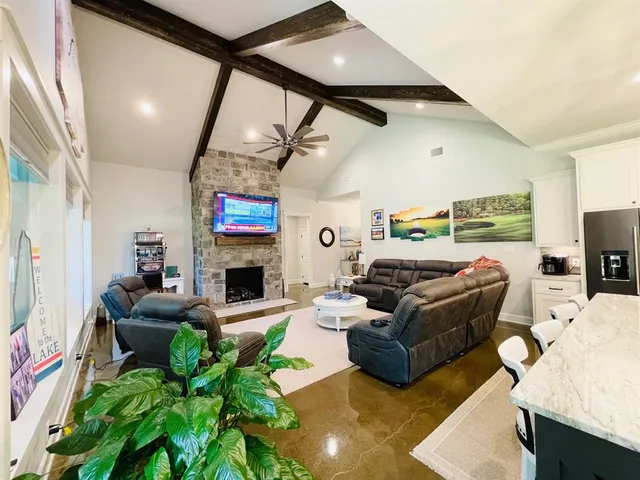 a living room with fireplace furniture and a window