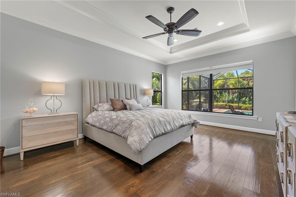 14517 Marsala Way Naples, FL 34109 - Photo 15 of 33 a spacious bedroom with a large bed and a chandelier