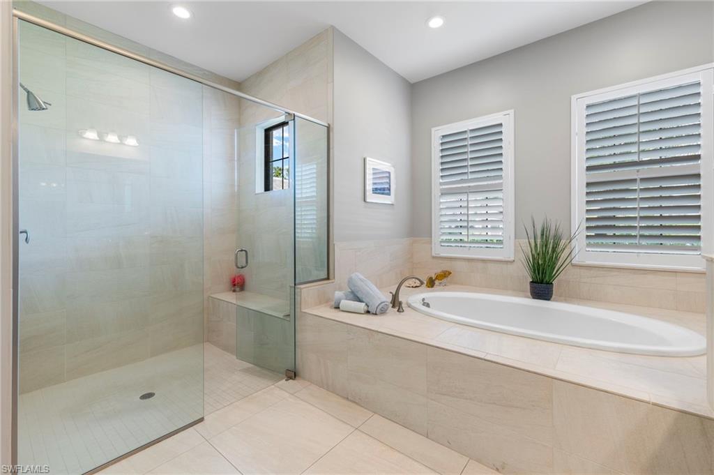 14517 Marsala Way Naples, FL 34109 - Photo 18 of 33 a bathroom with a tub a sink and a shower