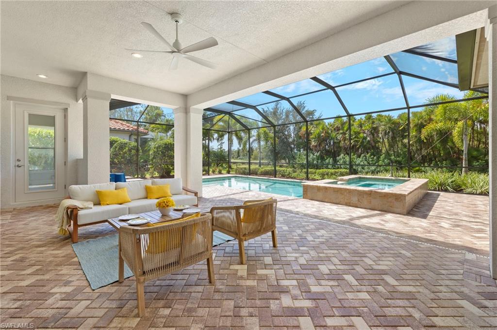 14517 Marsala Way Naples, FL 34109 - Photo 19 of 33 a living room with furniture and a floor to ceiling window