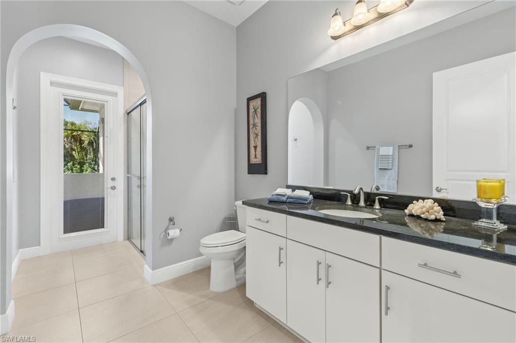 14517 Marsala Way Naples, FL 34109 - Photo 27 of 33 a spacious bathroom with a granite countertop sink mirror and toilet