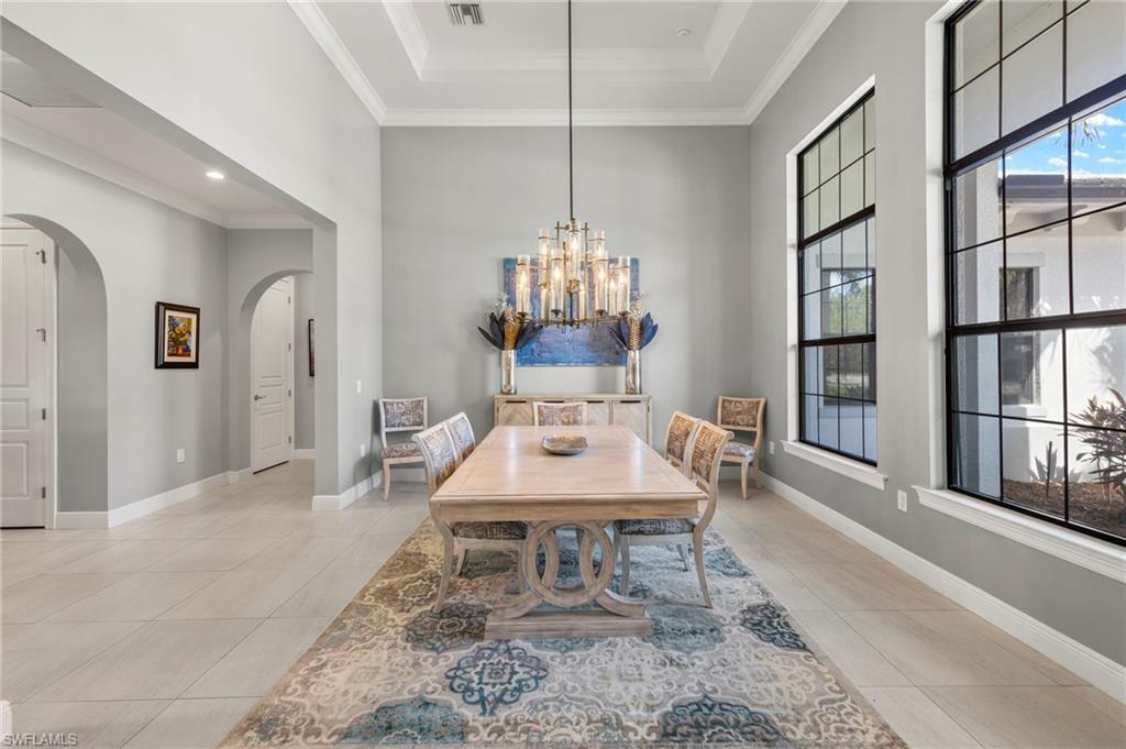 14517 Marsala Way Naples, FL 34109 - Photo 3 of 33 a dining room with furniture a chandelier and window