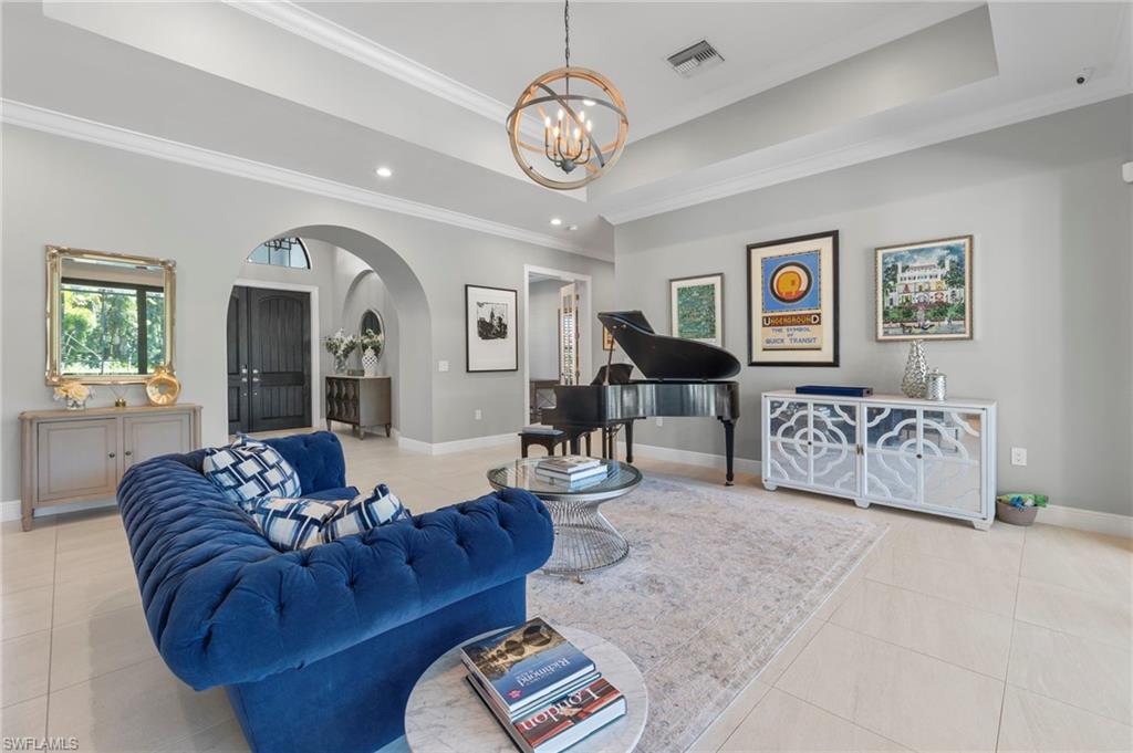 14517 Marsala Way Naples, FL 34109 - Photo 4 of 33 a living room with furniture and a chandelier