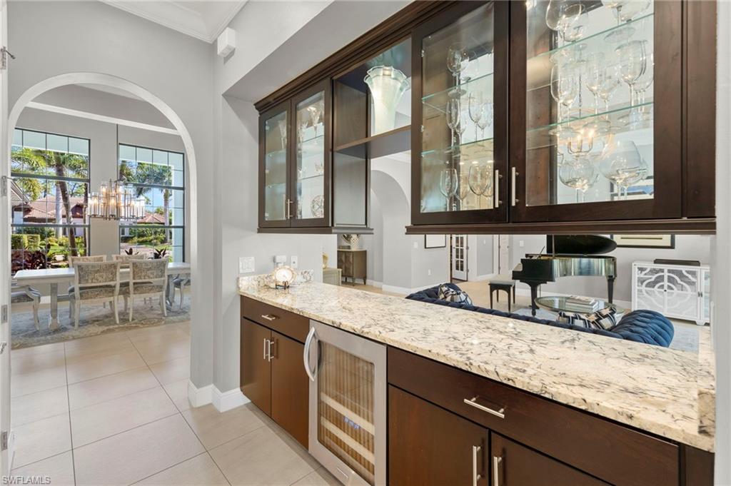 14517 Marsala Way Naples, FL 34109 - Photo 7 of 33 a bathroom with a granite countertop sink and a large mirror next to a window