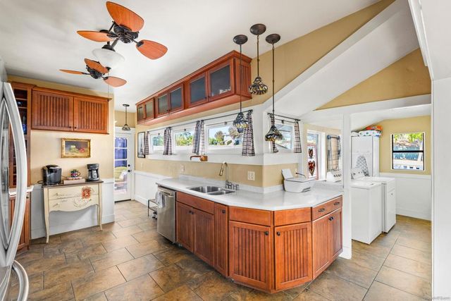 a kitchen with stainless steel appliances granite countertop a sink counter space cabinets and a stove